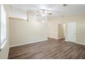 Bright living room featuring hardwood floors, a ceiling fan, and large windows at 3242 College St, Atlanta, GA 30337