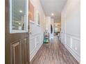 Inviting foyer with wood floors and elegant wall paneling leading to the living area at 450 Rockfern Ct, Lilburn, GA 30047