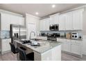 Eat in kitchen showcasing granite countertops, stainless steel appliances, and ample white cabinetry at 213 Yellowwood Way, Woodstock, GA 30188