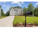 Charming two-story farmhouse with a well-manicured lawn, stylish mailbox and visible basketball hoop at 3617 Carson Se Ln, Smyrna, GA 30080