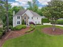 Stately two-story home with stone details, professional landscaping, and a mature tree at 641 Lake Overlook Dr, Canton, GA 30114