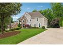 Beautiful two-story home with stone facade, well-maintained lawn, and extended driveway at 641 Lake Overlook Dr, Canton, GA 30114