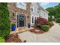 Inviting front entrance with stone accents, a decorative wreath, and colorful potted plants at 641 Lake Overlook Dr, Canton, GA 30114