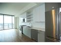 Contemporary kitchen boasts stainless steel appliances and large windows with city views at 788 W Marietta Nw St # 811, Atlanta, GA 30318
