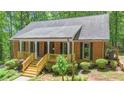 Exterior features brick facade, front porch and mature landscaping at 150 Gill Ln, Stockbridge, GA 30281