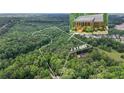 Aerial view highlighting the property's +/- 11.2 acres of wooded land and brick home at 150 Gill Ln, Stockbridge, GA 30281