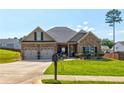 Charming brick home with a well-manicured front yard, two-car garage, and inviting curb appeal at 64 Citadel Dr, Hampton, GA 30228