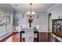 Formal dining room featuring elegant lighting, hardwood floors, and classic decor for sophisticated dining at 7115 Secret Rose, Douglasville, GA 30134
