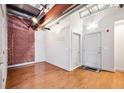 Stylish bedroom with hardwood flooring, exposed brick, and modern lighting at 1261 Caroline Se St # 108, Atlanta, GA 30307