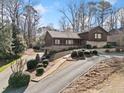 Aerial view of home featuring driveway, mature trees, and inviting landscape at 1905 Castleway Ne Ln, Atlanta, GA 30345