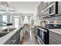 Modern kitchen featuring stainless steel appliances, sleek countertops, and ample cabinet space overlooking a dining area at 2711 Kemp Ct, Conyers, GA 30094