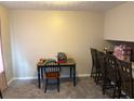 Cozy dining area featuring carpet floors, complemented by a table with green legs and a matching chair at 3464 Kingswood Trl, Decatur, GA 30034