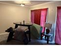 This dining room features carpet, pink curtains, and a dark colored table at 3464 Kingswood Trl, Decatur, GA 30034