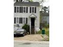A two-story home with black shutters, a stairway up to the covered front entry, and a paved driveway at 3464 Kingswood Trl, Decatur, GA 30034