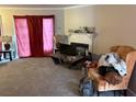 The living room has carpet, a fireplace, pink curtains, and a TV on a coffee table at 3464 Kingswood Trl, Decatur, GA 30034