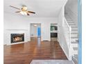 Bright living room features a cozy fireplace, hardwood floors, and staircase at 3468 Washington Way, Doraville, GA 30340