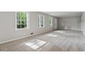 Bright and airy living room with neutral carpeting and natural light from large windows at 4616 Greensprings Rd, Atlanta, GA 30337
