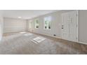 Bright living room with neutral carpet, light gray walls, and lots of natural light from multiple windows at 4616 Greensprings Rd, Atlanta, GA 30337