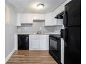 Functional kitchen featuring updated appliances, white cabinets, and granite countertops at 1151 Rankin St # 20A, Stone Mountain, GA 30083