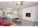 Open floor plan showcasing a living area with a modern fireplace that flows into a kitchen at 1887 King Charles Sw Rd, Atlanta, GA 30331