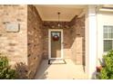A welcoming front porch with brick siding and space for decorations at 2706 Park Land Ln, Snellville, GA 30078