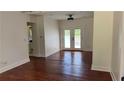 Bright living room boasts gleaming hardwood floors and a glass-paneled door for natural light at 5510 Mason Rd, Atlanta, GA 30349