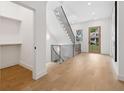 Entryway features light wood floors, a modern black metal staircase, and a view of the outdoors at 1287 Star Ne Dr, Brookhaven, GA 30319
