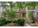 Brick townhome featuring a welcoming front porch, stone steps, and a meticulously maintained yard at 855 Mountain View Nw Ter, Marietta, GA 30064