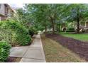 Paved pathway showcasing mature trees, lush greenery, and manicured lawns in a serene community setting at 855 Mountain View Nw Ter, Marietta, GA 30064