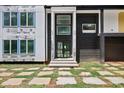 Home's entryway featuring black brick accents and a stone-paved front yard at 1410 Lavista Ne Rd, Atlanta, GA 30324