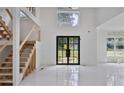 Spacious foyer with high ceilings, a modern staircase, and large windows for ample natural light at 1410 Lavista Ne Rd, Atlanta, GA 30324