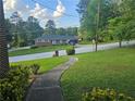 Traditional home with a well-kept lawn and a paved walkway at 2379 Manassas Ln, Decatur, GA 30034