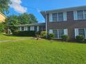 Well-maintained brick home featuring a lush green lawn and manicured shrubs at 2379 Manassas Ln, Decatur, GA 30034