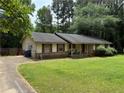Traditional single-story home with red shutters and a covered front porch at 108 Fair Oaks Se Dr, Conyers, GA 30094