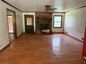 Spacious living room with hardwood floors and a classic brick fireplace at 108 Fair Oaks Se Dr, Conyers, GA 30094
