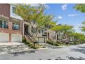 Charming street view of well-maintained townhouses with lush green trees, enhancing the neighborhood's appeal at 5882 Riverstone Cir # 15, Atlanta, GA 30339