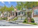 Street view of townhomes with brick and grey stone exterior, plus driveways with two-car garages at 5882 Riverstone Cir # 15, Atlanta, GA 30339