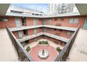 Upper view of landscaped courtyard with decorative fountain and multi-story apartment balconies at 91 Rumson Rd, Atlanta, GA 30305