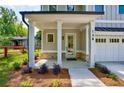 Inviting front porch with elegant columns, brick accents, and professionally landscaped garden beds at 138 Beutell St, Norcross, GA 30071