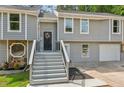 Charming home with gray siding, stone accents, and a welcoming front porch with a decorative 'Welcome' sign at 300 Rocky Cove Trl, Lawrenceville, GA 30044