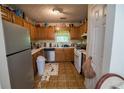 Functional kitchen with stainless steel refrigerator, wood cabinets, and ample countertop space at 501 Textbook Ct, Lawrenceville, GA 30044
