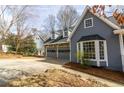 Stylish two-story home with a stone-accented garage, bay window and blue horizontal siding at 1931 Amber Dawn Way, Lawrenceville, GA 30043