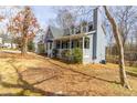 Inviting two-story home with a covered front porch, stone chimney, and well-maintained lawn at 1931 Amber Dawn Way, Lawrenceville, GA 30043