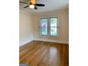 Bedroom with hardwood floors, neutral paint, and window bringing in natural light at 242 12Th Ne St # 1A, Atlanta, GA 30309