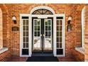 Close up of grand front door with transom and sidelights, as well as address plaque at 242 12Th Ne St # 1A, Atlanta, GA 30309