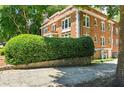 Brick building with lush greenery in the background at 242 12Th Ne St # 1A, Atlanta, GA 30309