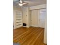 Living room features hardwood floors, built-in bookshelves, and neutral paint scheme at 242 12Th Ne St # 1A, Atlanta, GA 30309