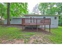 Exterior view of a house showing a wooden deck overlooking the grassy backyard at 3963 Holland Ct, Douglasville, GA 30135