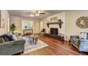 Inviting living room featuring hardwood floors, neutral paint, and a cozy fireplace at 3963 Holland Ct, Douglasville, GA 30135