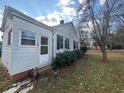 Side view of a cozy bungalow with a small yard and neat landscaping at 5111 Newark Ave, Clarkdale, GA 30111